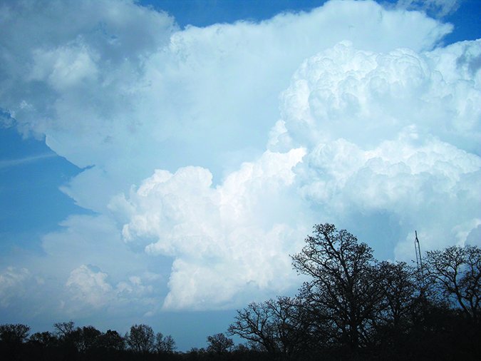 cumulonimbus tower in the foreground with a developing anvil in the background